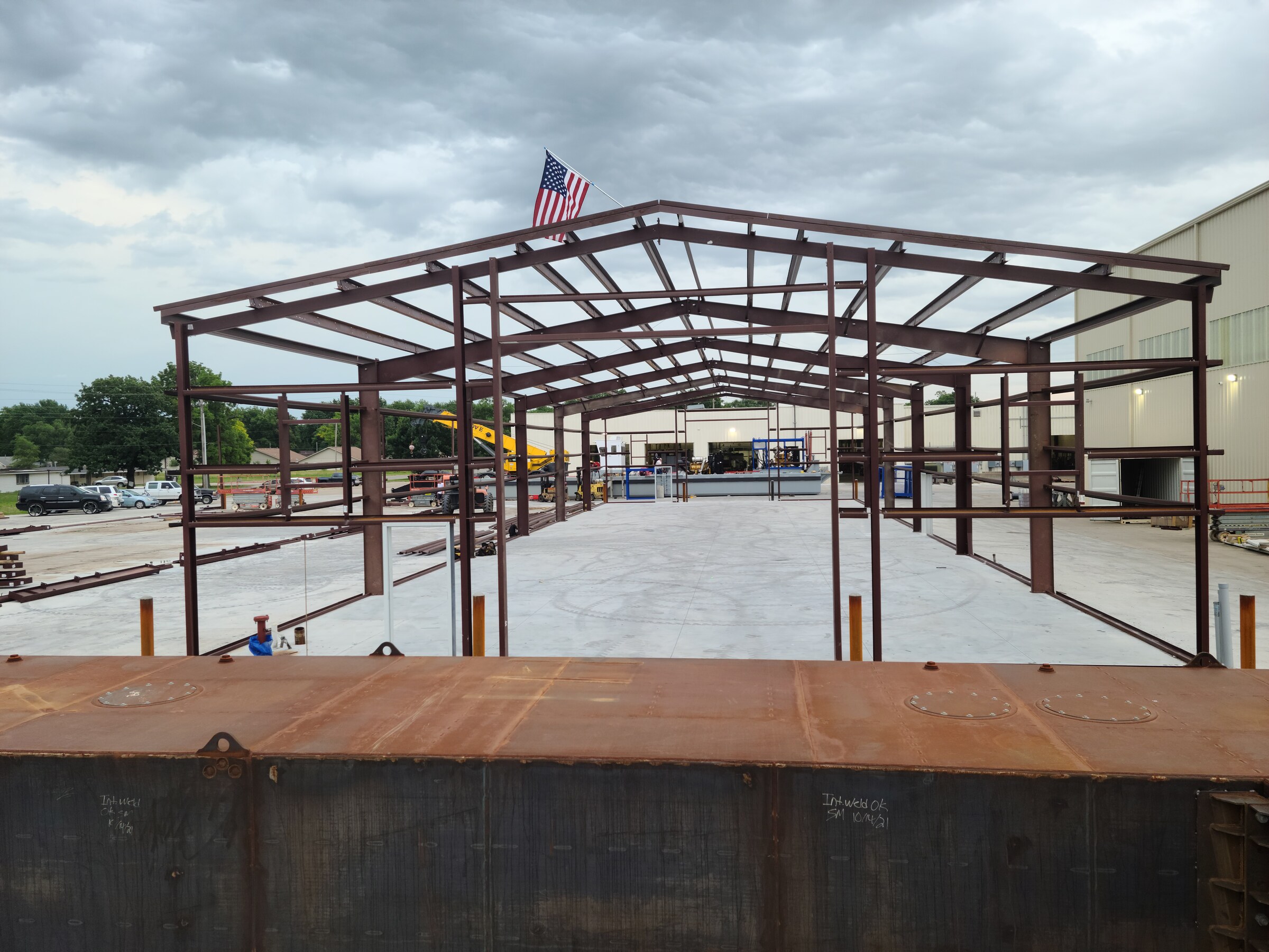 Steel building frame under erection on a concrete slab