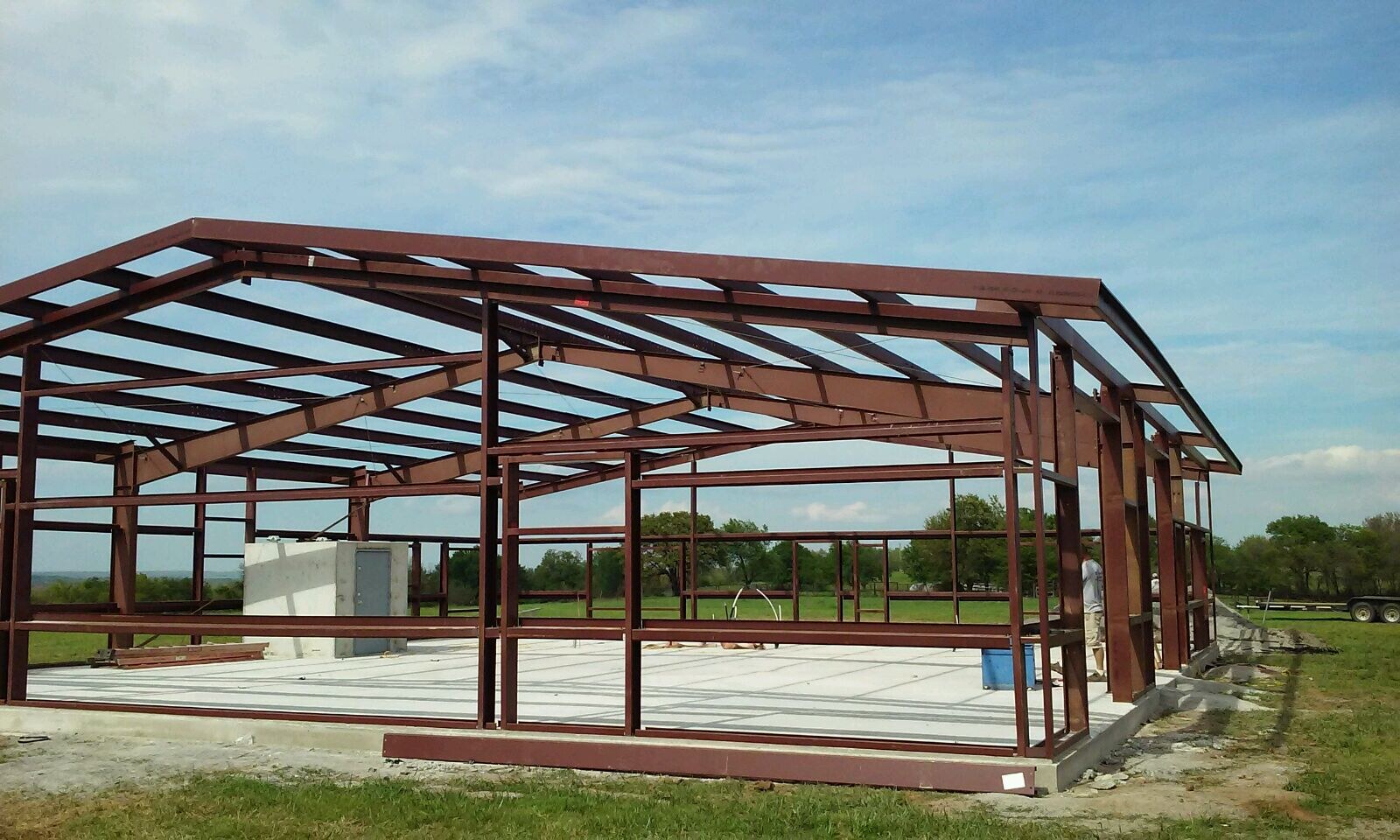 Gabled red-iron building frame viewed from the corner